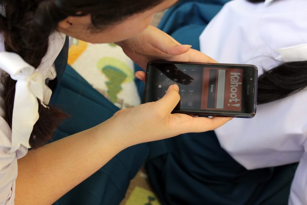Pupil interacting with a game-based resource called Kahoot on a smartphone