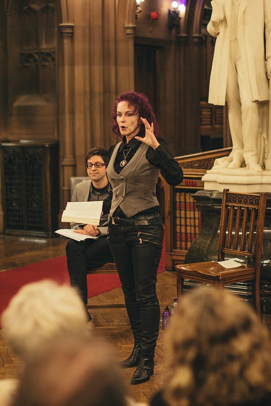 Rosie Garland performing in front of audience at John Rylands Library