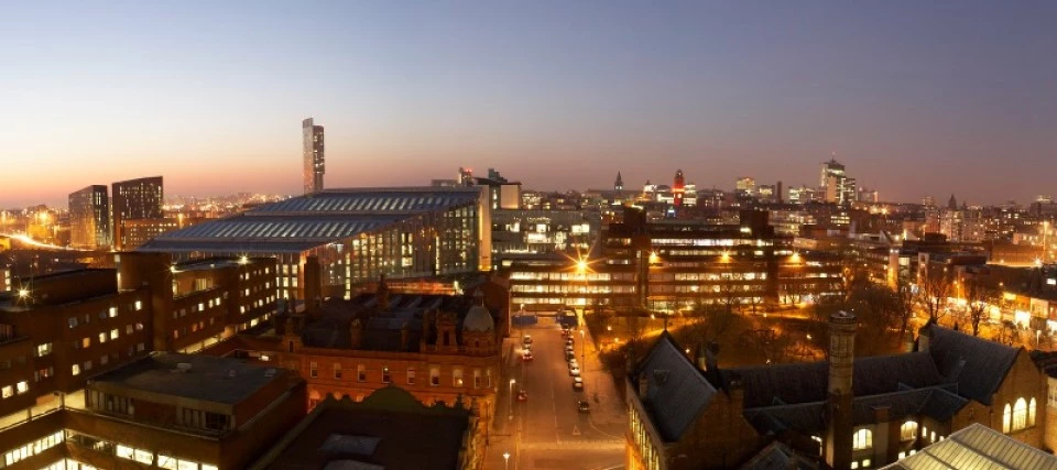 manchester city scape at night taken from the top of the manchester school of art