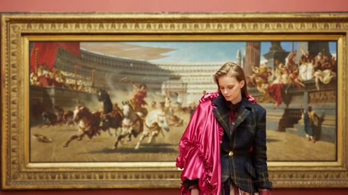 A fashion model stood in front of a classical painting
