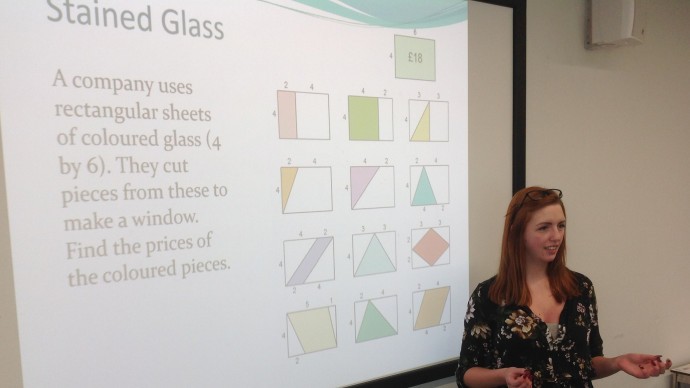 A teacher delivering a presentation using realistic mathematics education examples