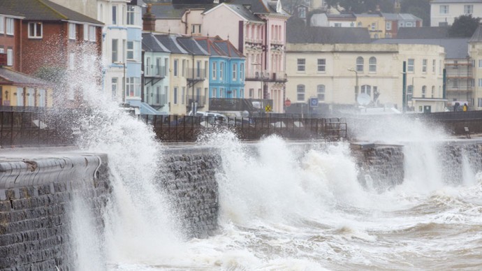 Large waves breaking against a sea wall in Devon, UK