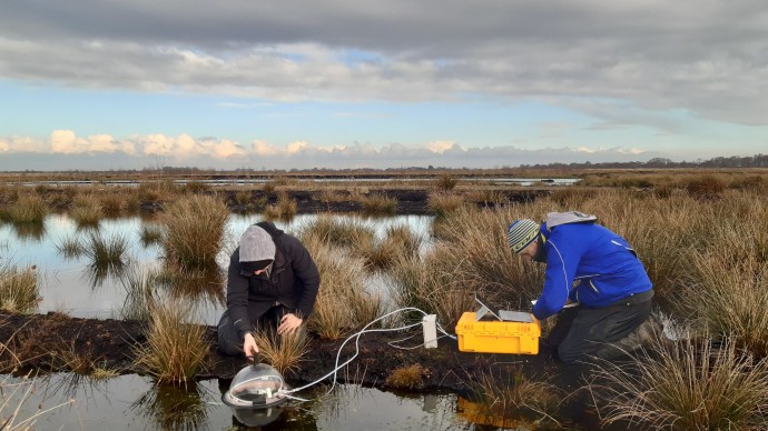 Researchers taking measurements from a peat bog in the Peak District
