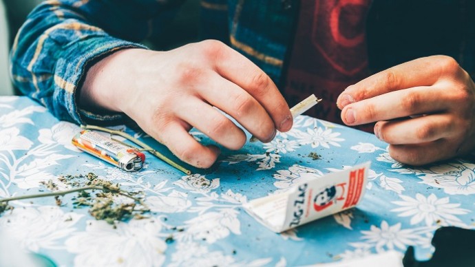 A drug user rolling a joint