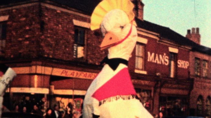 Large mother goose figure forming part of a procession along a northern high street