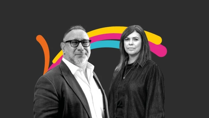 Professor Saul Becker and Professor Hannah Smithson standing facing the camera. The background is black with illustrative colourful swirls.