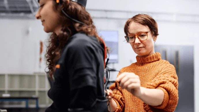 Researcher Nikki Ray fitting sensors to a woman's back