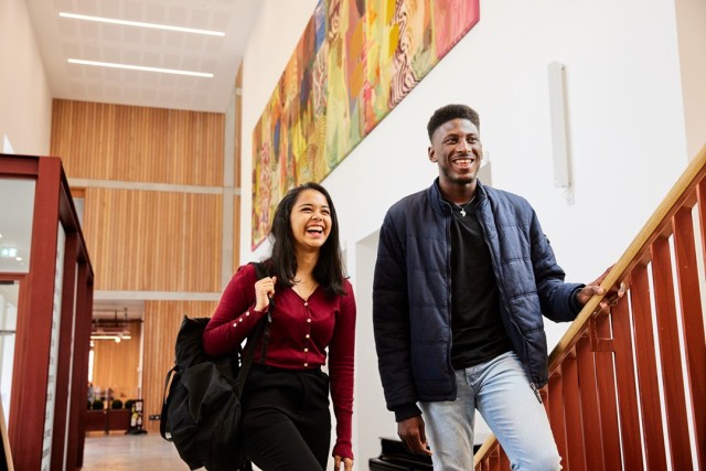 Two students ascending a staircase in Grosvenor East