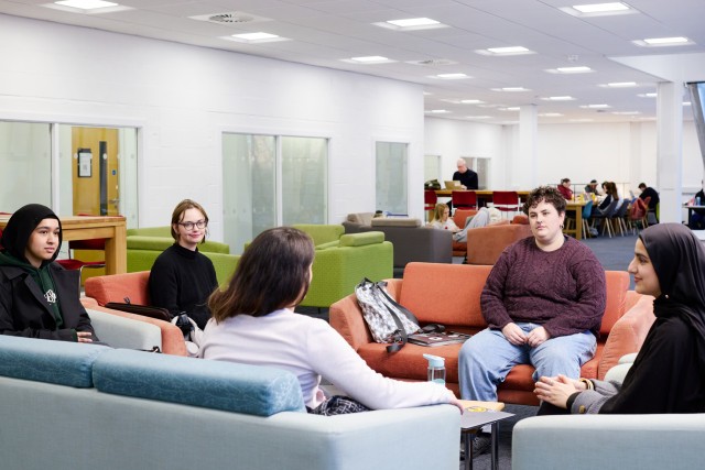 Students chatting in the ground floor area of the Library