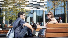 Students socialising on benches outside Brooks