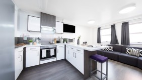 Mill Point modern kitchen with oven, fridge, cupboards and breakfast bar station