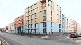 Ropemaker Court viewed from across the road, a six storey, multi-coloured apartment building