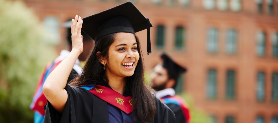 Graduate touching hat