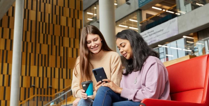 Students looking at a phone