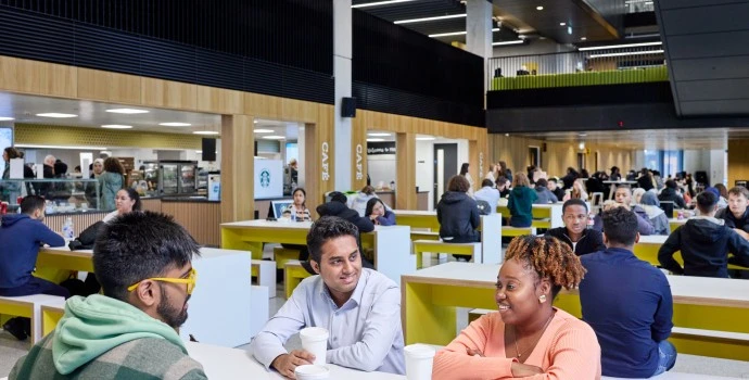 three people of colour students chatting amongst themselves