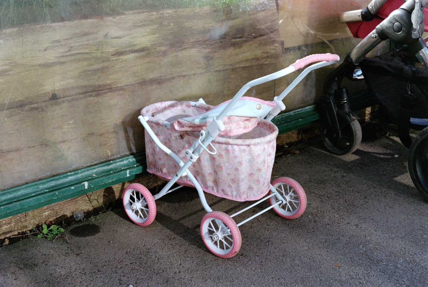 A pink pram parked outside a children's centre